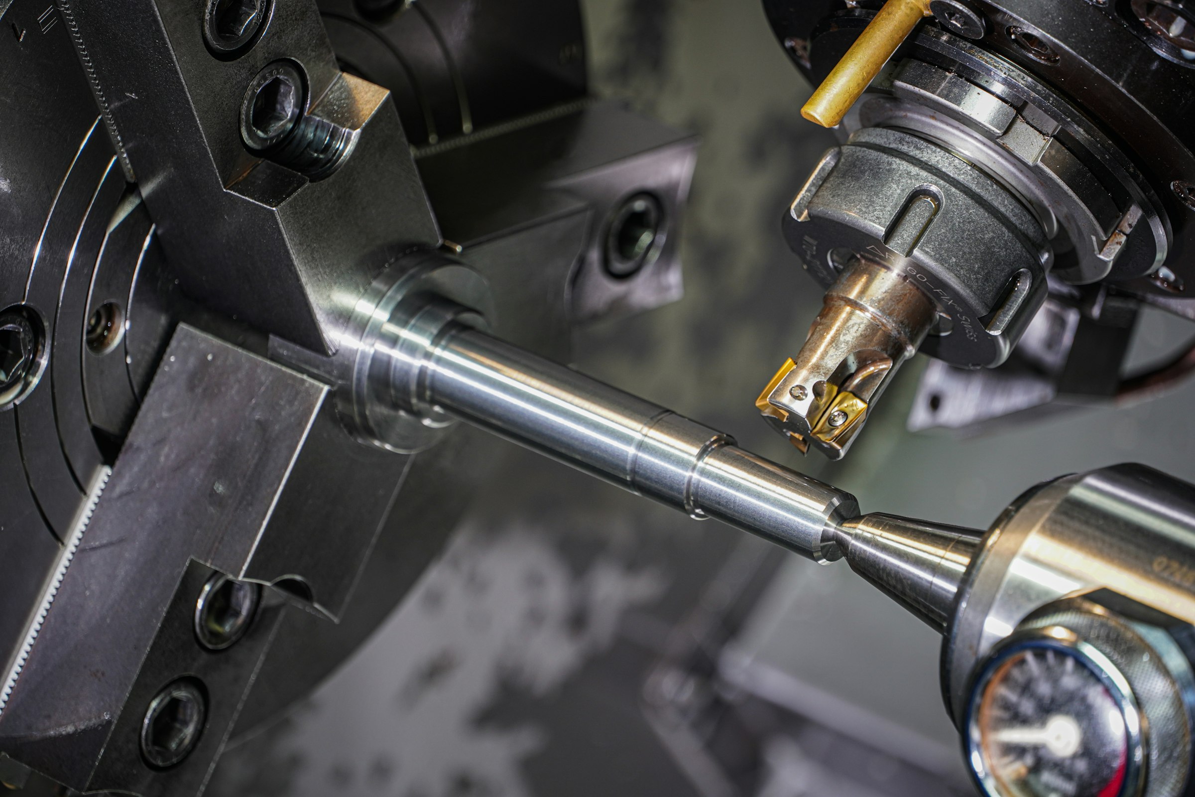 Steel rod being machined on a precision CNC lathe